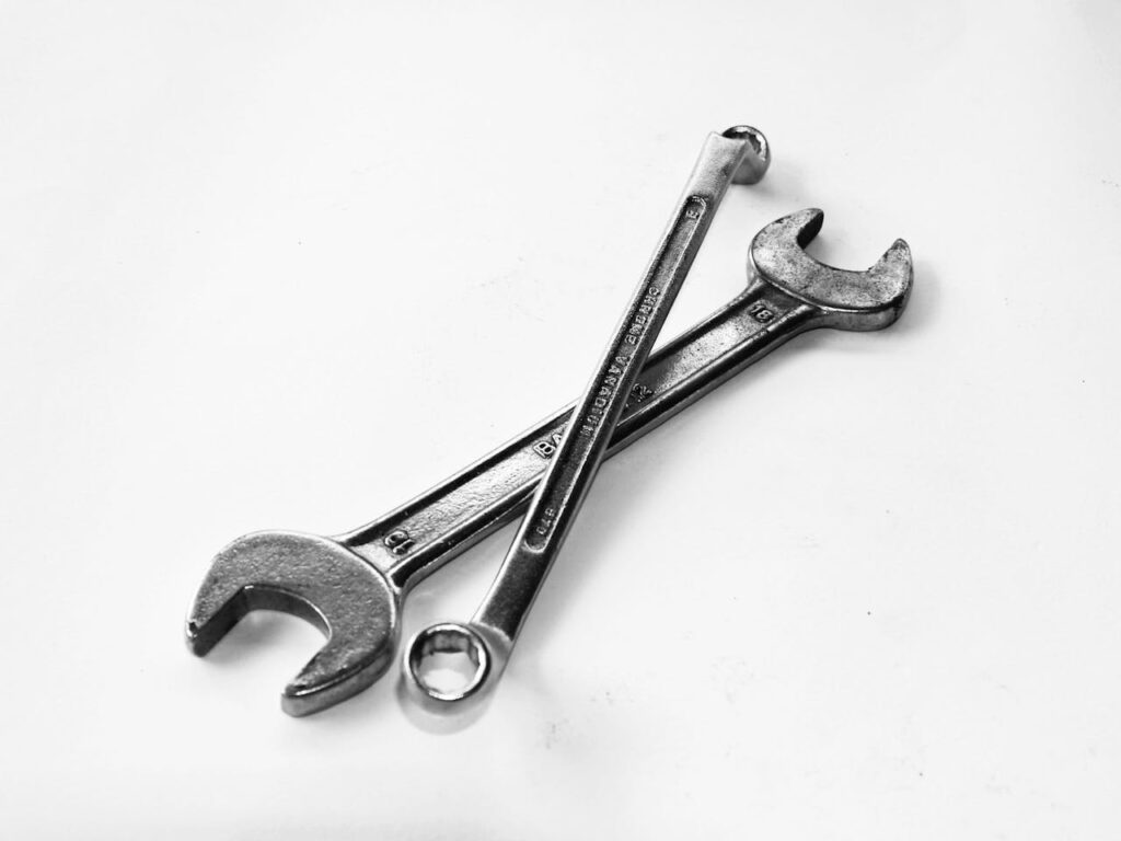 pexels-photo-210881 A pair of crossed metal wrenches on a clean white surface.